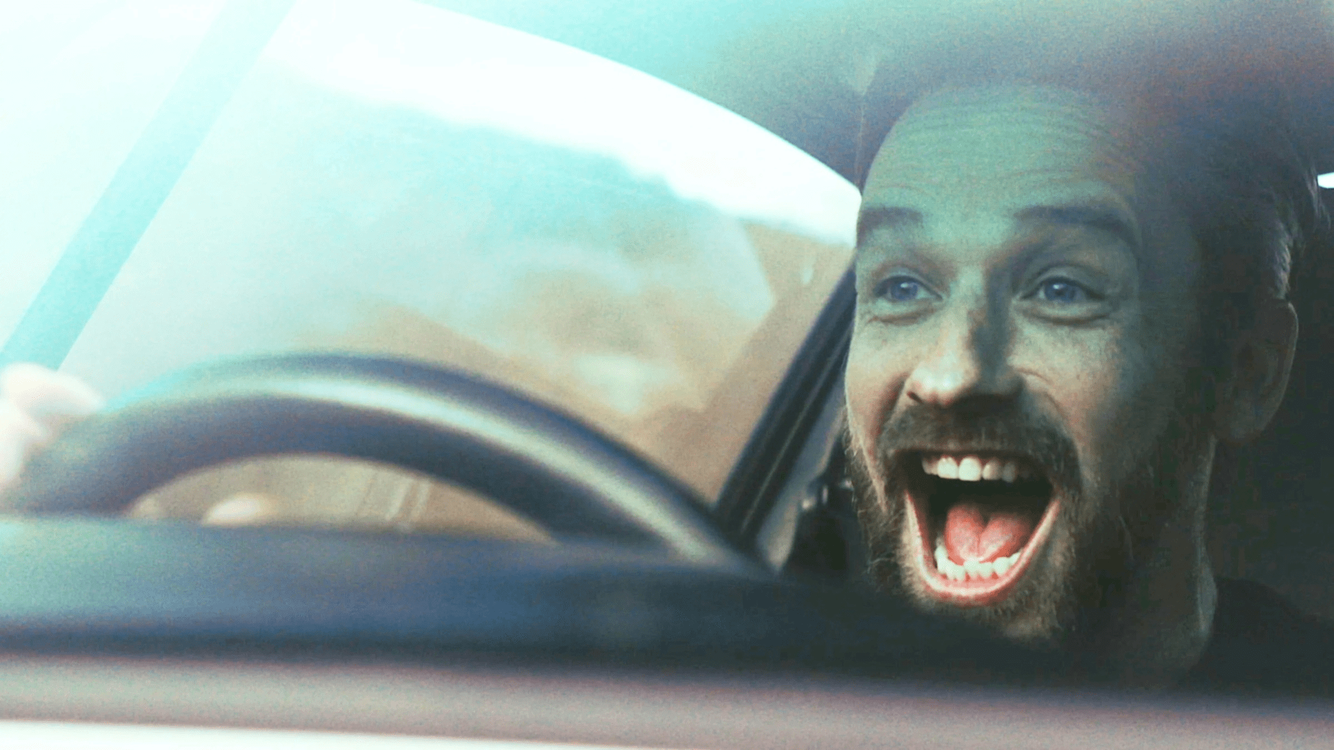 Man excitedly driving car