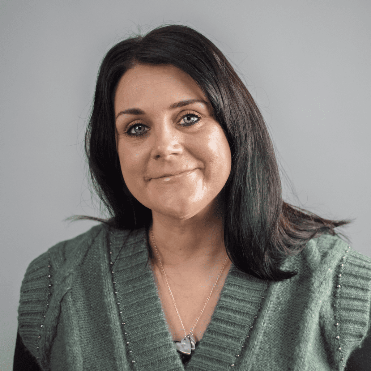 Woman with dark hair smiling
